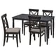 Black wooden chairs with grey cushions around black square dining table.