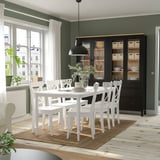 Modern dining room with DANDERYD table & chairs, bright white, sturdy metal legs, surrounded by dark cabinet, large window, natural lighting.