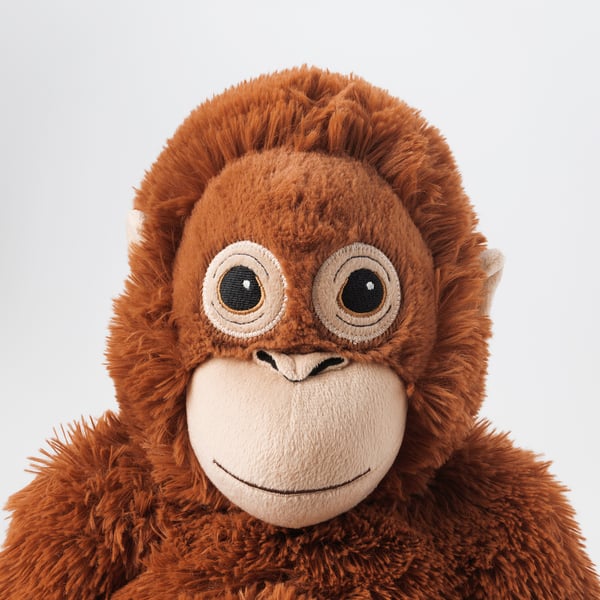 Plush orangutan toy, soft, detailed face, big eyes, friendly smile, made from polyester.
