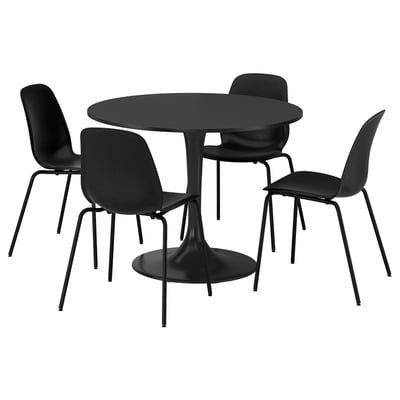 A black DOCKSTA round dining set with a table and four chairs featuring sleek, modern designs.