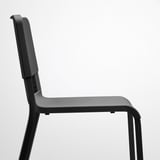 Modern black stacking chair, durable plastic seat and back, sturdy metal legs.