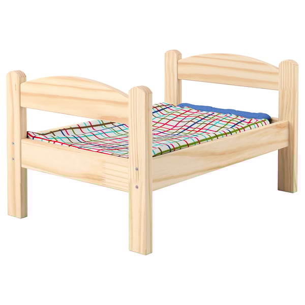 Wooden kids doll bed with colorful bedding.