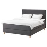 DUNVIK bed: dark grey, upholstered with wood legs, rectangular shape, soft headboard, white linens.