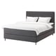 Grey DUNVIK bed, modern design with soft headboard, fully upholstered in fabric, white bedding.