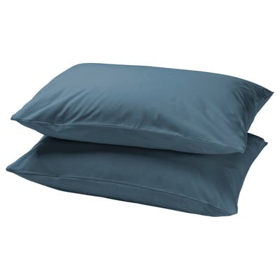 Stacked teal DVALA cotton pillowcases, rectangular.