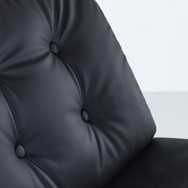 Dark grey leather upholstered chair with tufted cushioning, showcasing high-quality texture and design.