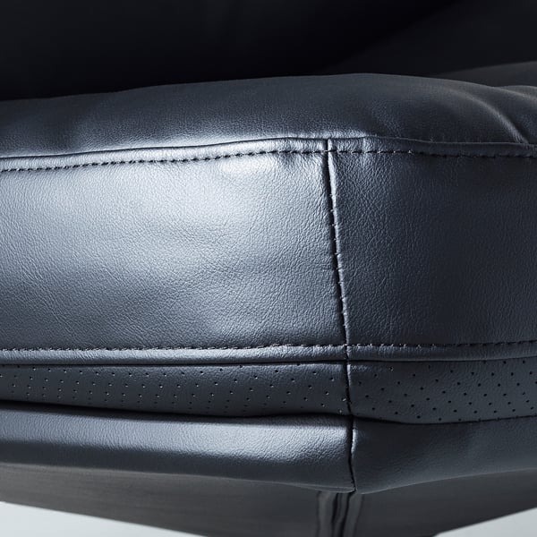 Close-up of a sleek black leather chair with neat stitching and fine perforations.