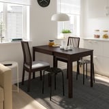 Modern kitchen with EKEDALEN dining set, pendant light, dishes, plant, and blinds.