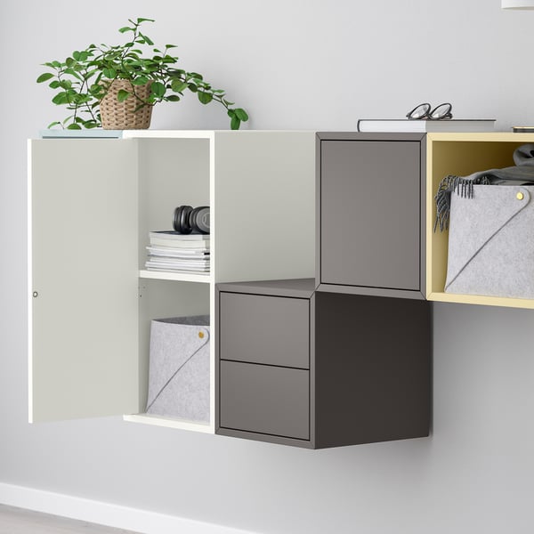 Modern wall-mounted storage with open and closed cabinets for flexible organization. A plant and personal items are stored; the shelf is adjustable.