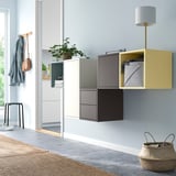 Colorful EKET wall storage with cubes and shelves, lamp, and basket.