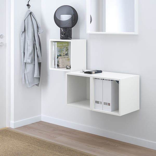 EKET white wall unit. Small, modern storage with museum shelf, open & closed sections. Hangs high, near a coat hook.