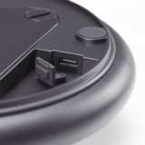 Close-up of a sleek black usb-c port on a compact device, emphasizing its high-quality design and functionality.