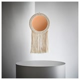 Unique circular woven wall hanging with mirror center and long fringes, adding warmth and style.