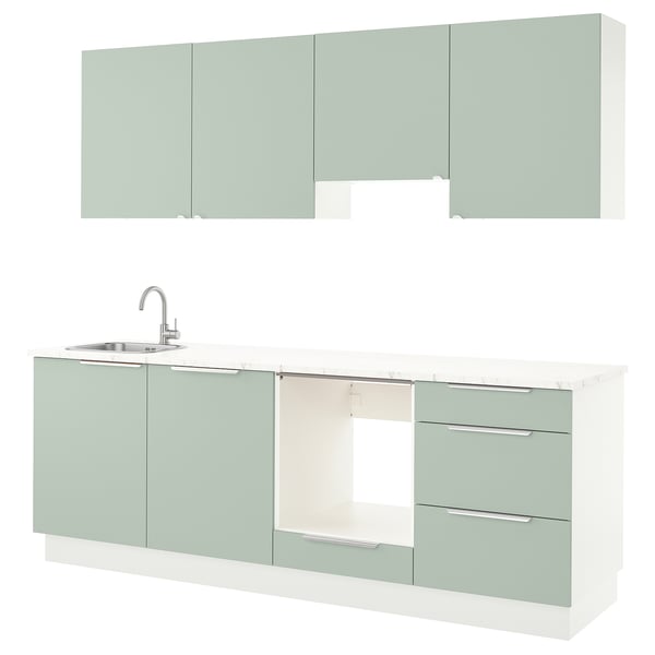 Modern kitchen unit in green with sleek drawers, sink, and cabinets.