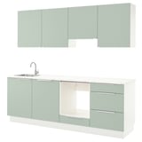 Modern kitchen unit in green with sleek drawers, sink, and cabinets.