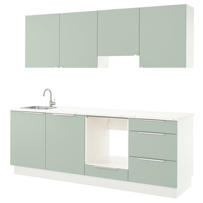 Modern kitchen unit in green with sleek drawers, sink, and cabinets.