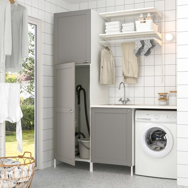 Grey ENHET laundry setup with sink, storage, washing machine, and hanging space.