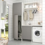 Grey ENHET laundry setup with sink, storage, washing machine, and hanging space.