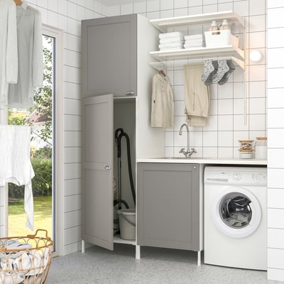 Grey ENHET laundry setup with sink, storage, washing machine, and hanging space.