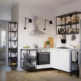 Modern white and black kitchen with a sleek stove, open shelves, and metal accessories.