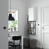 Modern kitchen with ENHET storage: tall white cabinet, black open frame, window table with chair, light, and plant.