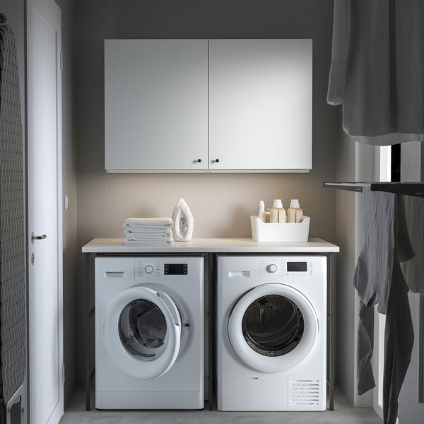 Modern laundry: ENHET cabinets, washing machine, dryer. Storage-friendly, minimalist.