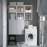 ENHET storage in laundry room with cabinet and shelves.