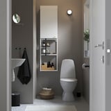 Small modern bathroom: white toilet, sink, shelves. Dark walls, light floor.