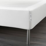 Hildegarde white bed base with metal legs, designed to elevate and support mattresses.