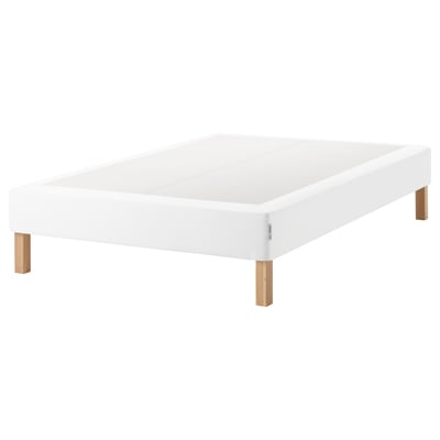 White espevar platform bed with wooden legs.