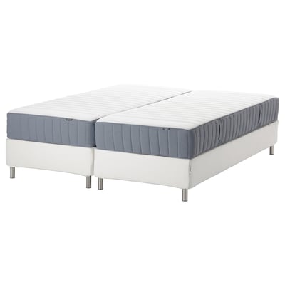 Two blue-gray mattresses on a white bed frame, offering support and comfort.