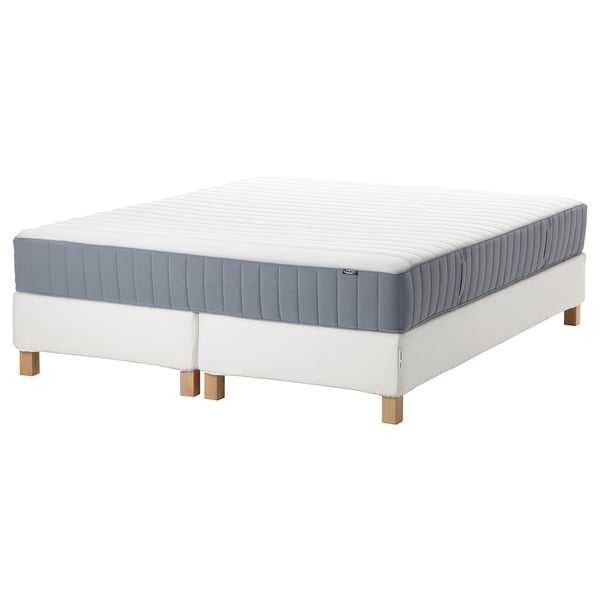 An espevar/valevag mattress set. The item is white with gray borders, rectangular, and raised on wooden legs.