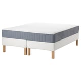A white ESPEVÄR/VALEVÅG bed with a blue-gray mattress. It has wooden legs and a rectangular shape.