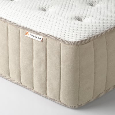 Close-up of a high-quality mattress, showcasing its firm pocket sprung design and natural materials, designed for optimal comfort and support.