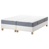 Two white mattresses on stand, blue edges, rectangular shape, wooden legs.