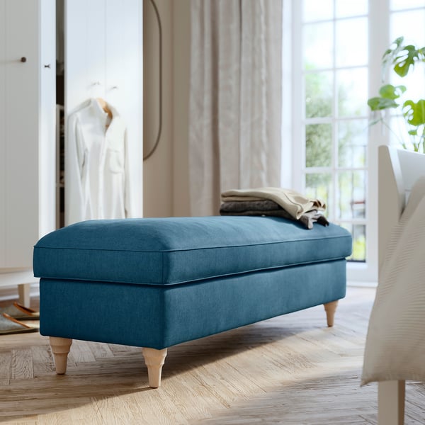 ESSEBODA blue upholstered bench with wooden legs. Modern design, rectangular shape. Ideal for seating and storage.