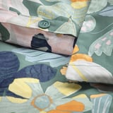 Close-up of a multi-colored floral duvet cover with button closure, showcasing its soft, breathable fabric.