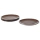 Image shows two sets of brown FÄRGKLAR plates, round with simple design, made of stoneware.