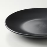 Black side plate with smooth, glossy finish on white background.