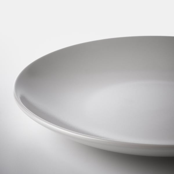 Smooth, round, white plate with sleek edge; elegant simplicity.