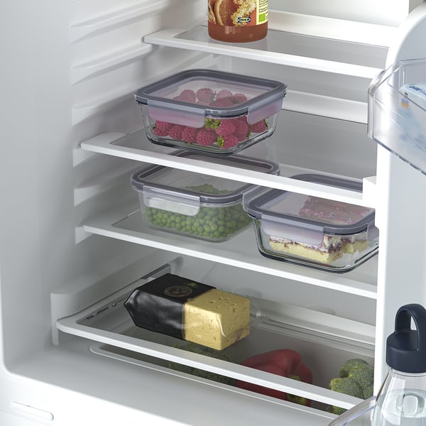 Refrigerator with adjustable shelves, storing various food items like berries, vegetable, cheese, and dessert. Led light inside.