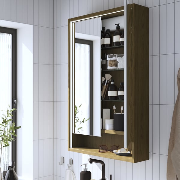 Mirror cabinet with lighting, open shelf, and integrated lighting.