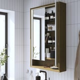 Mirror cabinet with lighting, open shelf, and integrated lighting.