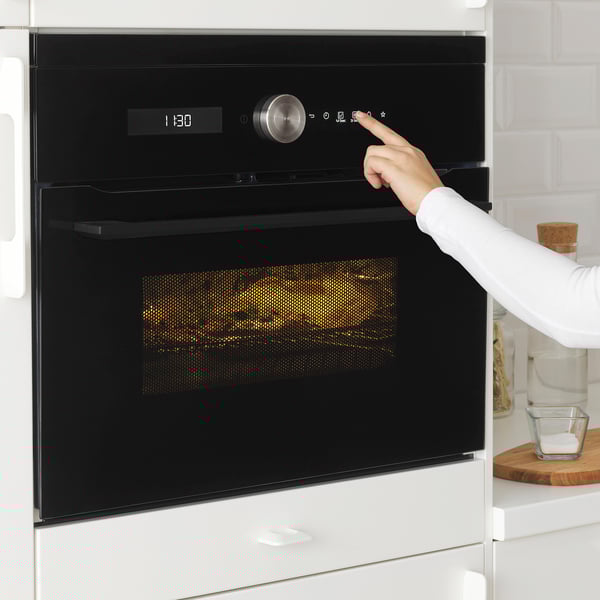 Microwave button press in white kitchen, 1:30 pm.