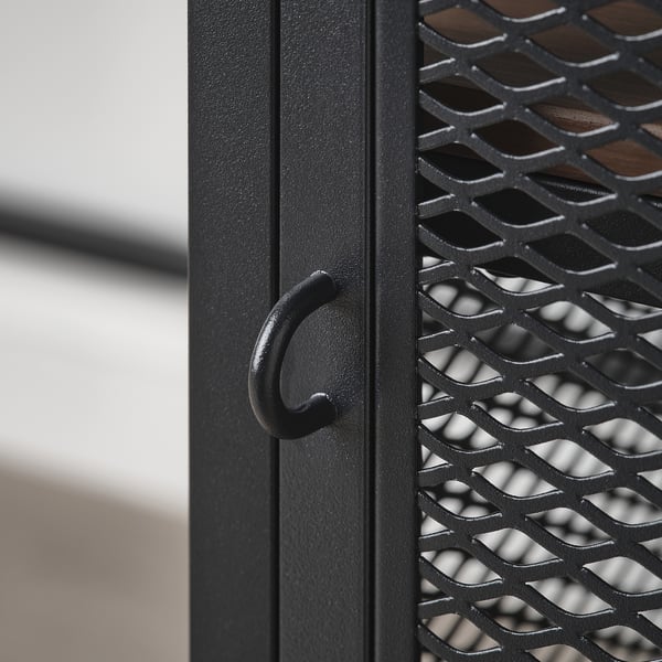 Close-up of metal drawer handle and mesh pattern on FJÄLLBO desk, showcasing its robust and modern design.