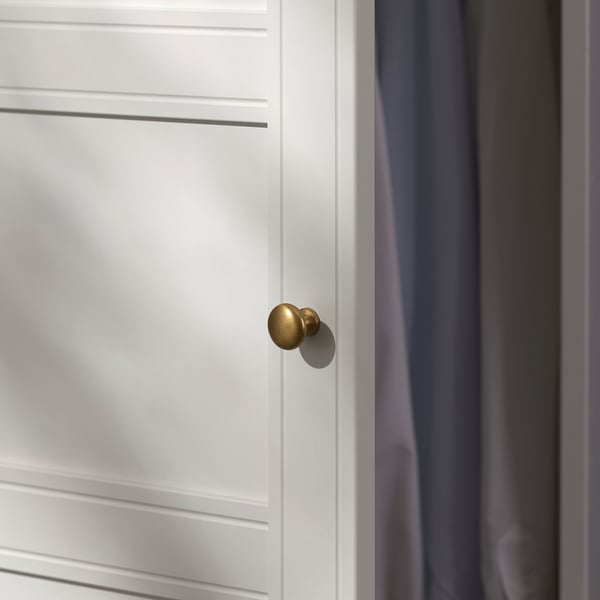 Close-up of a sleek, white door with subtle grooves and a polished gold handle.