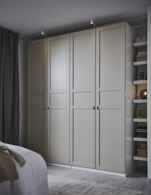 Modern bedroom light grey FLISBERGET wardrobe with three paneled, groove detailed doors. Soft closing hinges. Matte finish.