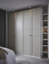 Modern bedroom light grey FLISBERGET wardrobe with three paneled, groove detailed doors. Soft closing hinges. Matte finish.