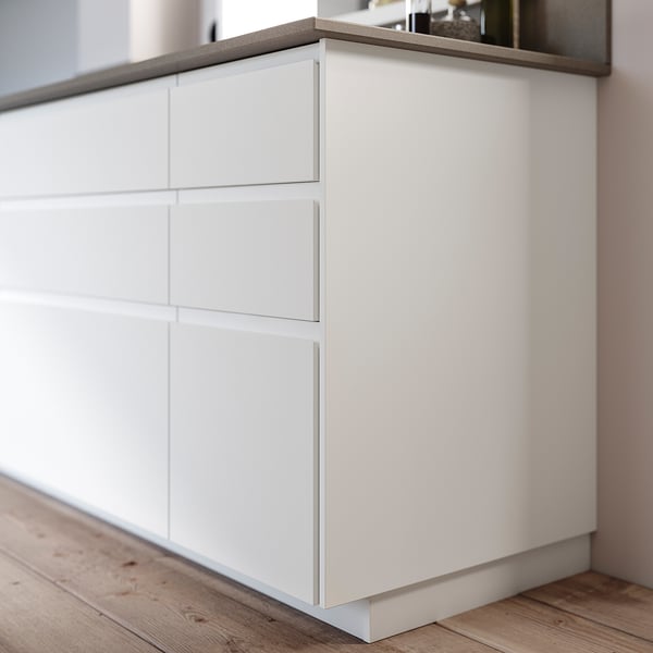 White FÖRBÄTTRA cabinet, 3 drawers, wood floor.