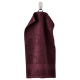 Dark maroon FREDRIKSJÖN cotton towel with ribbed edges hanging.